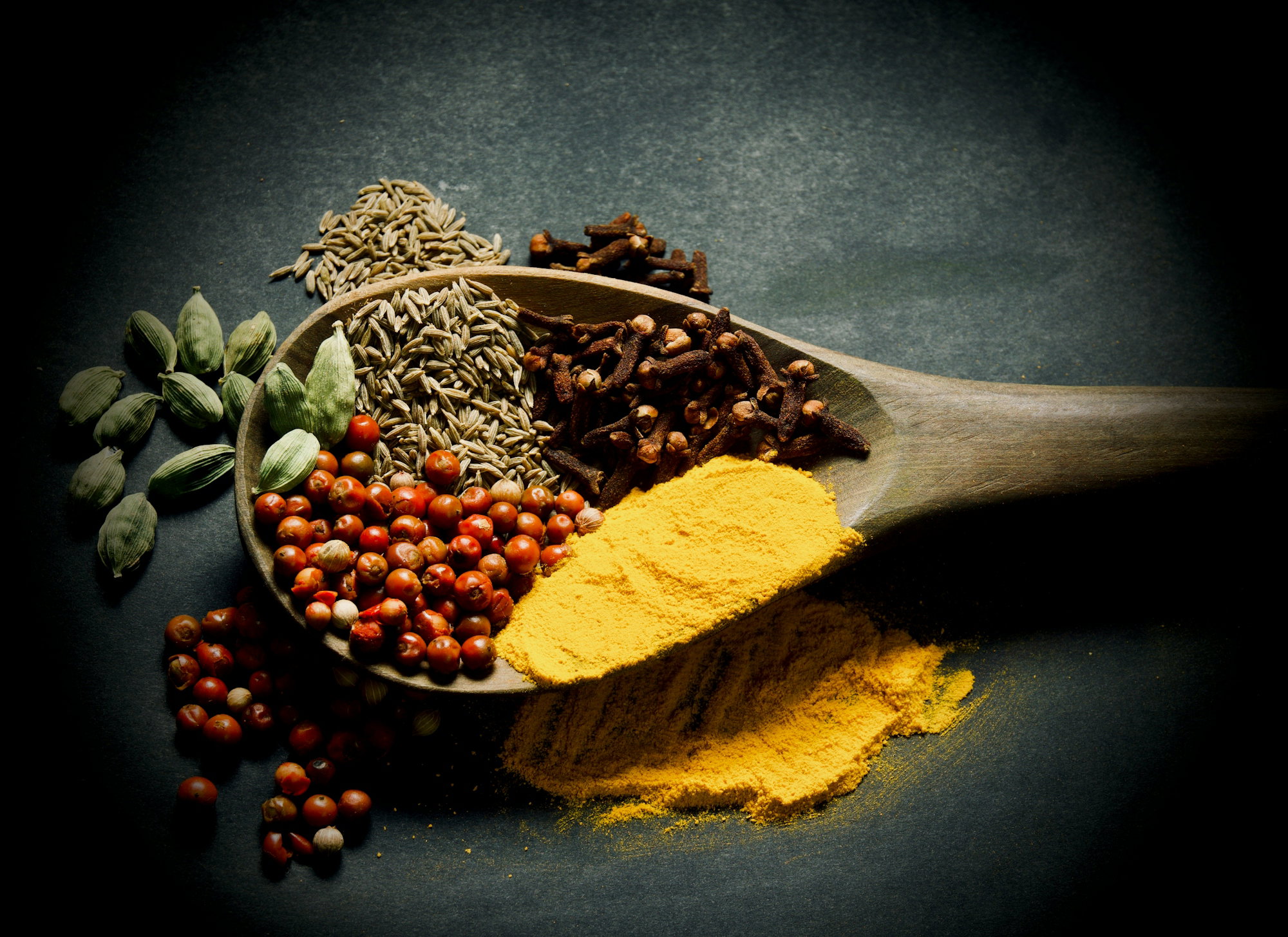 a-wooden-spoon-filled-with-different-types-of-spices.jpg a wooden spoon filled with different types of spices